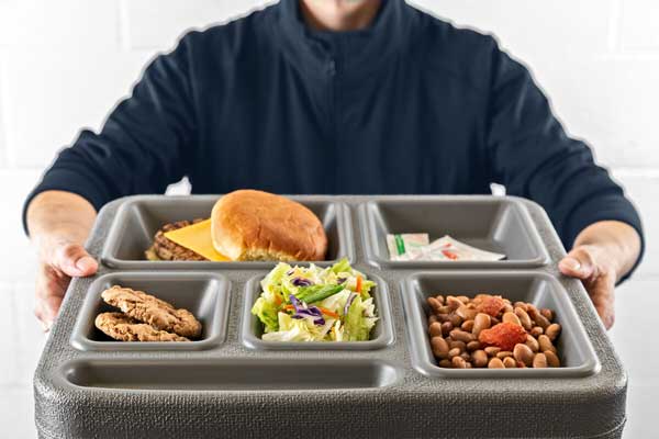 Person holding a tray of food